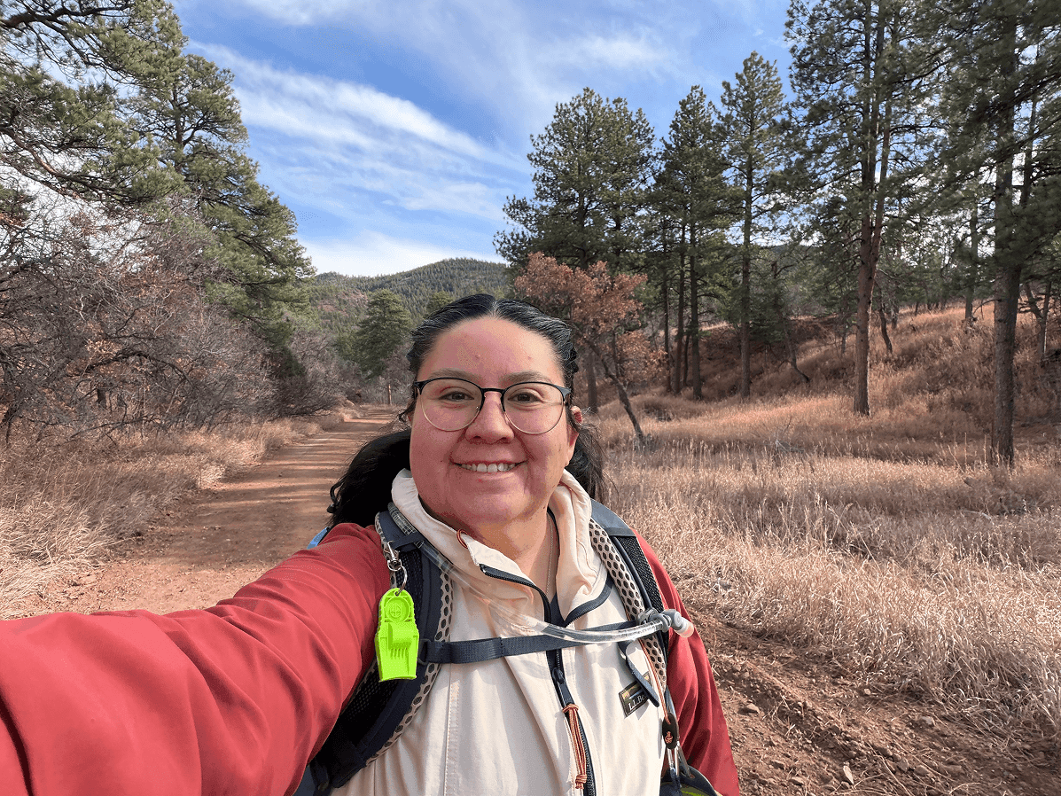 Sabrina smiling on a mountain overlook trail